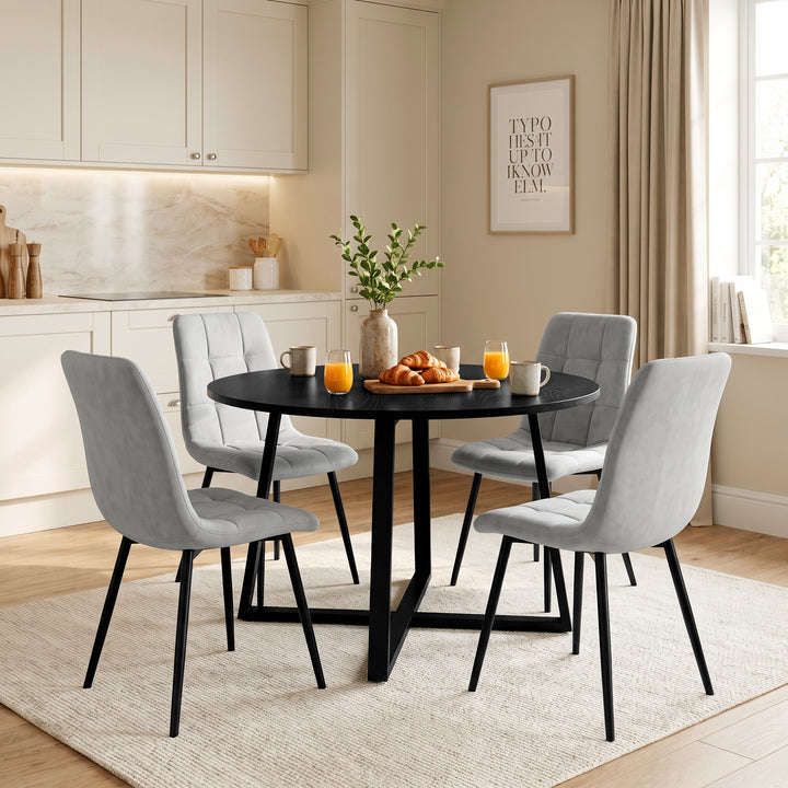 [Light Grey | Black Wood] Kyvon round dining table set in panelled dining room with four light grey velvet chairs