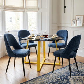 [Blue | Tinted] Kyvon 4 seater round glass dining set with Tinted tabletop, gold legs and blue chairs in a dining room