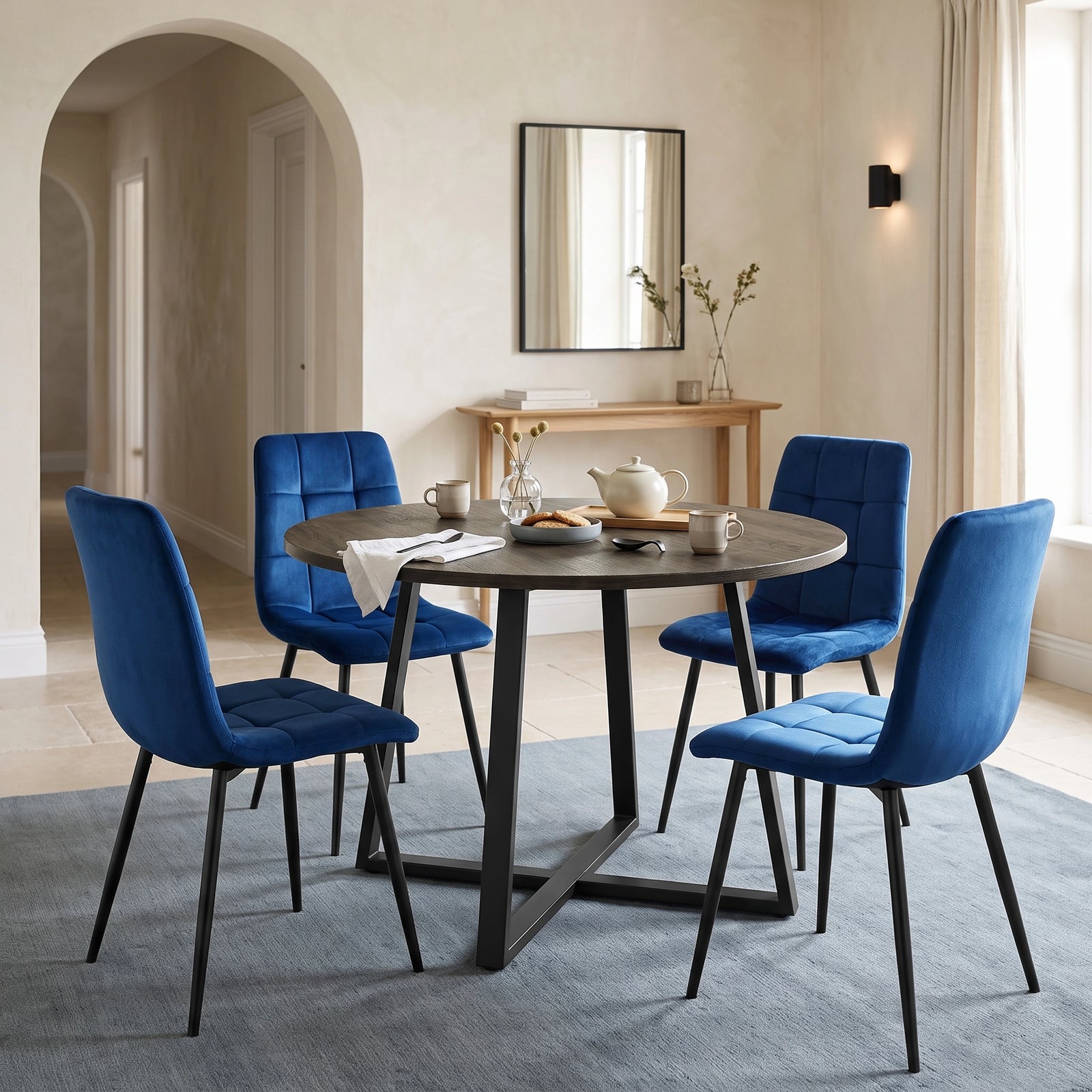 [Blue | Dark Wood] Kyvon round dining table set with 4 blue velvet chairs in an arched dining room