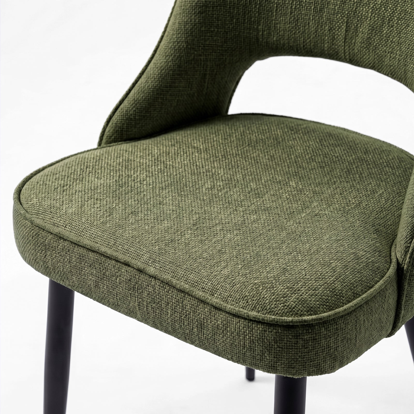 [Green | Tinted] Close-up of the 4 seater Kyvon green upholstered fabric comfy chair seat with black metal legs