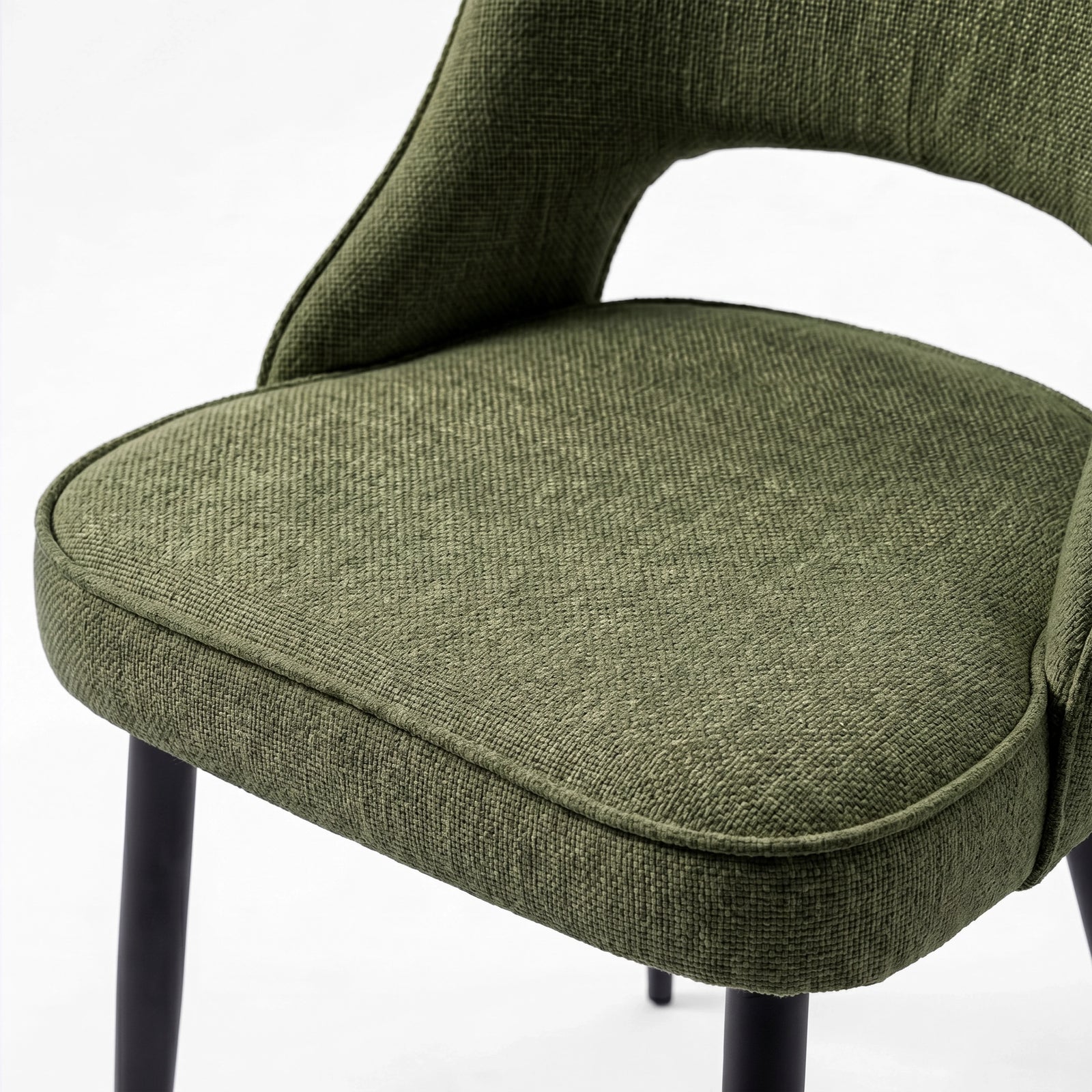 [Green | Tinted] Close-up of the 4 seater Kyvon green upholstered fabric comfy chair seat with black metal legs