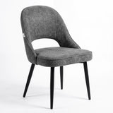 [Grey | Clear] Kyvon grey upholstered fabric comfy curve chair angled view with rounded back and cushioned seat