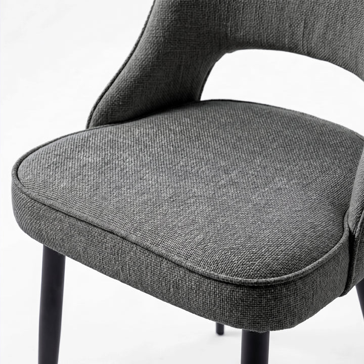 [Grey] Close-up of Kyvon 4-seater grey upholstered fabric comfy curve chair seat with black metal legs