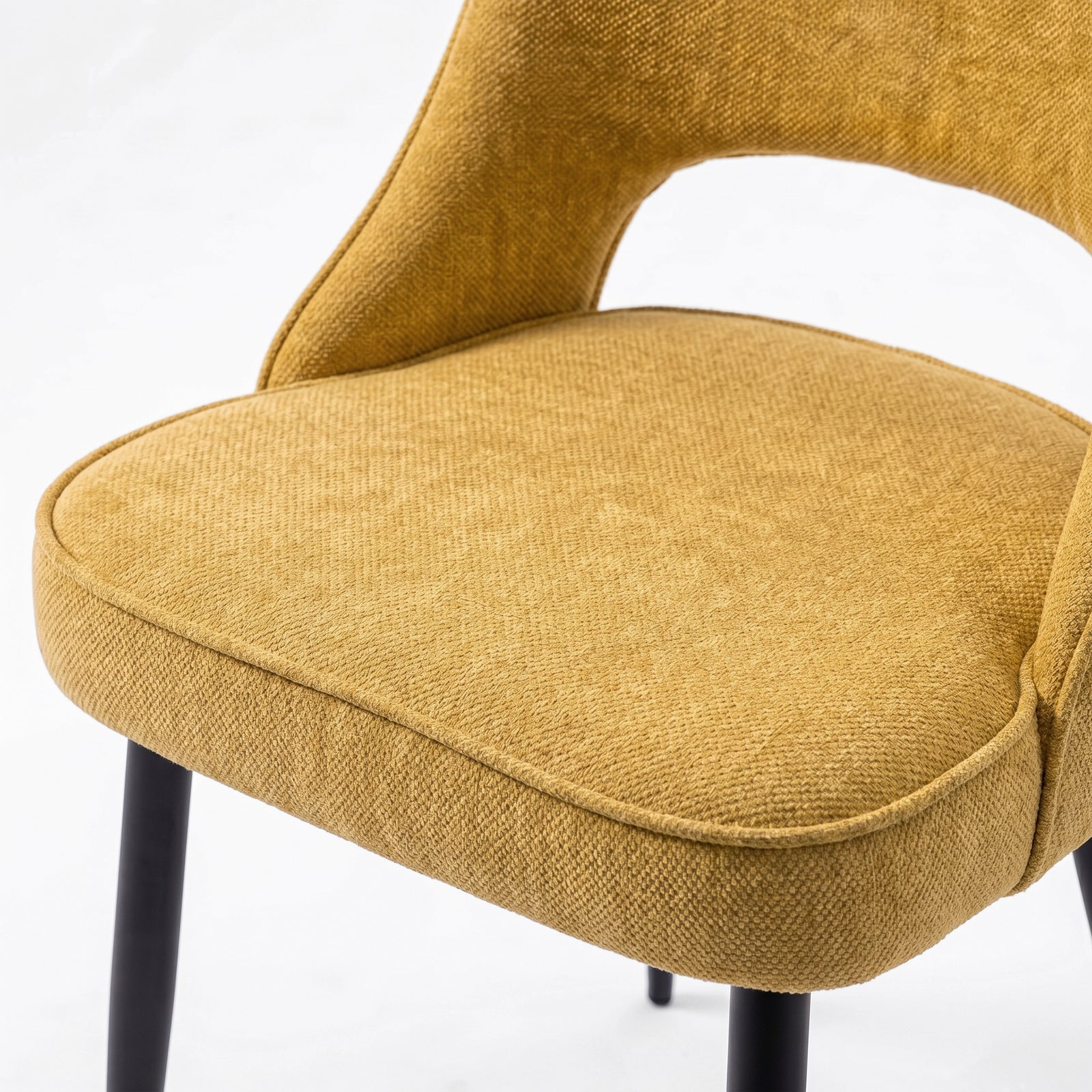 [Mustard | Clear] Close-up of Kyvon 4-seater mustard upholstered fabric comfy curve chair seat with black metal legs