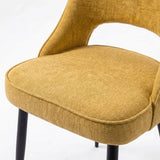 [Mustard | Tinted] Close-up of the 4 seater Kyvon mustard upholstered fabric comfy chair seat with black metal legs