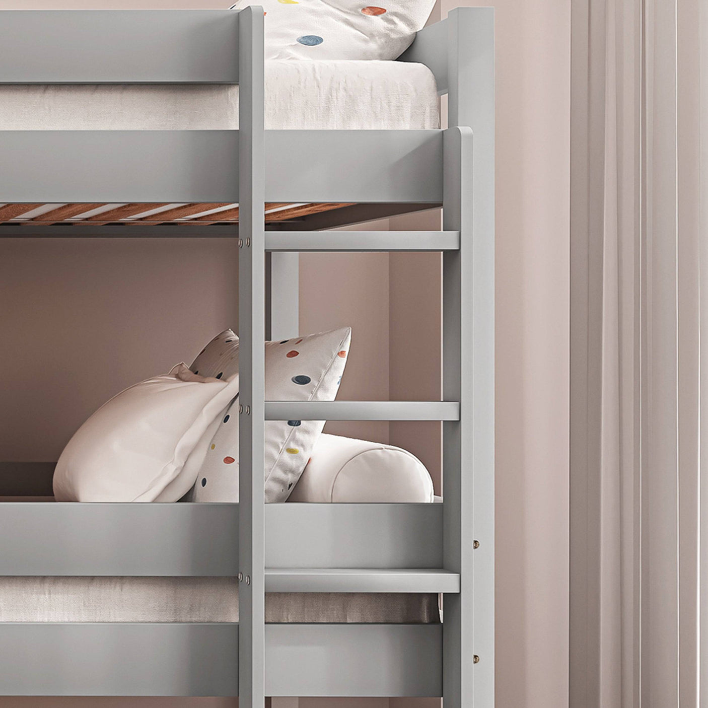 Detail of upper ladder and safety rails on grey triple bunk bed, ensuring safe climbing for kids.
