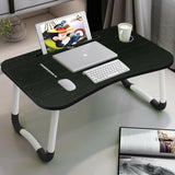 Black laptop desk table with tablet slot, cup holder, and foldable legs for home or office use.