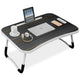 Laptop on tables with tablet slot, cup holder, and striped wooden finish design.