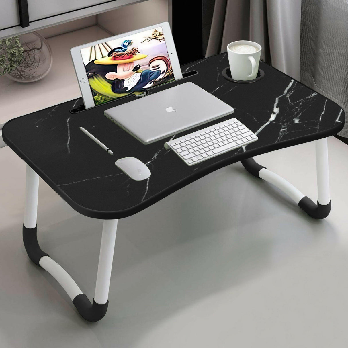 Laptop tray with black marble design, cup holder, and tablet slot for home office use.