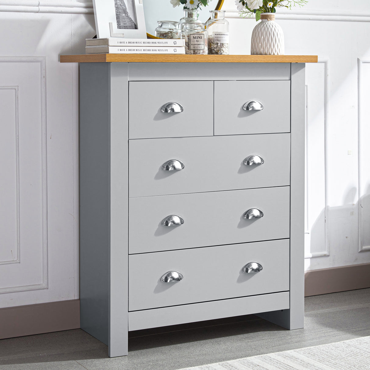 Large chest of drawers in grey with five spacious drawers and a wooden top for storage.