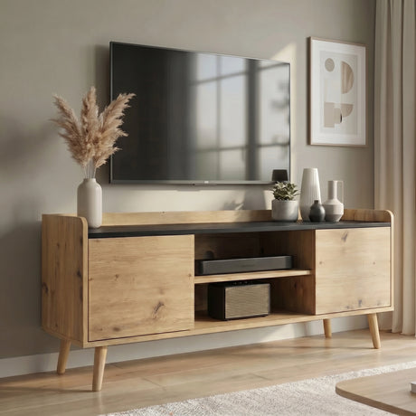[Oak] Larvik Natural TV Stand Unit with Storage 112cm Black Top positioned under a wall-mounted TV with a vase of pampas grass, decorative ceramic pottery, and a small potted plant