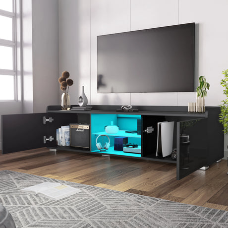 Modern black entertainment console with open shelf displaying electronic devices in a living room setting.