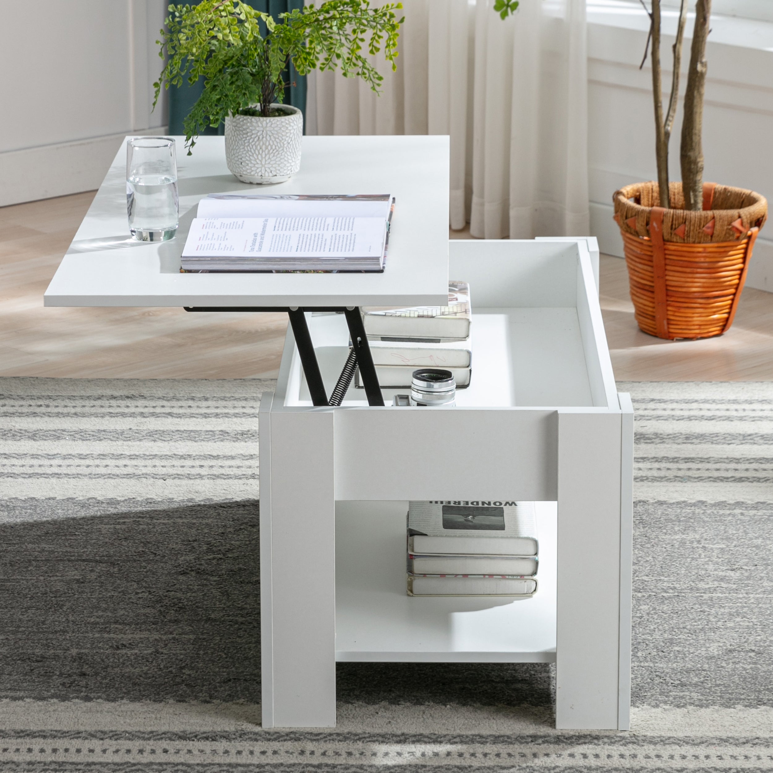 White lift-top coffee table uk with a lower storage compartment, books stacked on the bottom shelf.