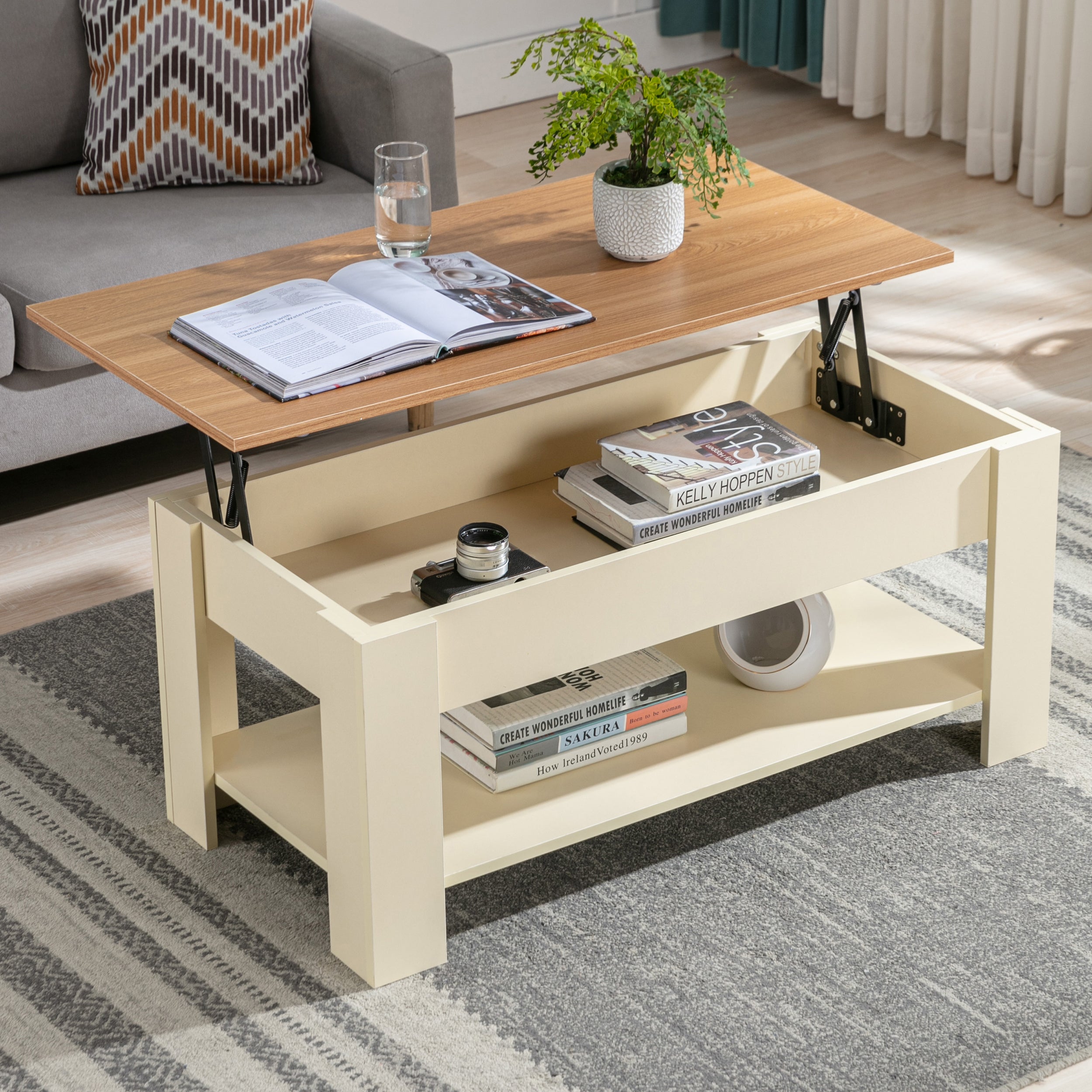 Lift top coffee tables with a light wood finish and beige base, featuring a lower shelf for storage.