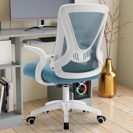 Adjustable chair with mesh backrest and flip-up armrests, placed near a PC workstation for ultimate comfort.