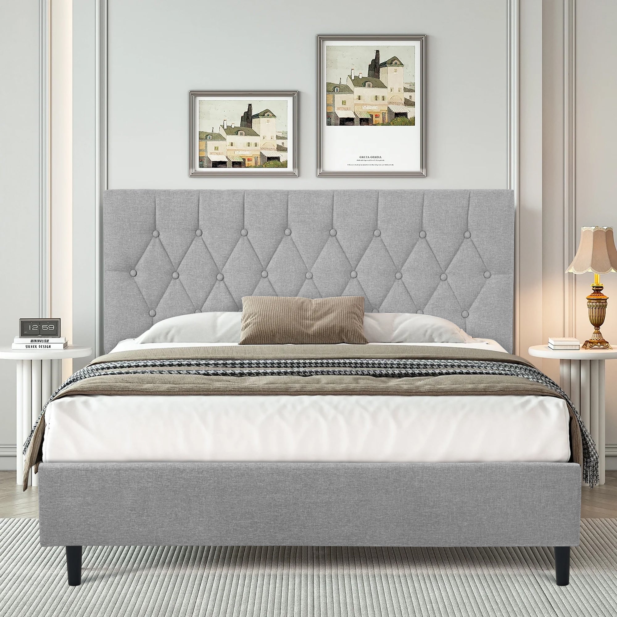 Light grey bed frame with tufted headboard in a modern bedroom setting.