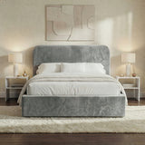 Front view of light grey velvet double ottoman bed positioned between bedside tables in a neutral interior