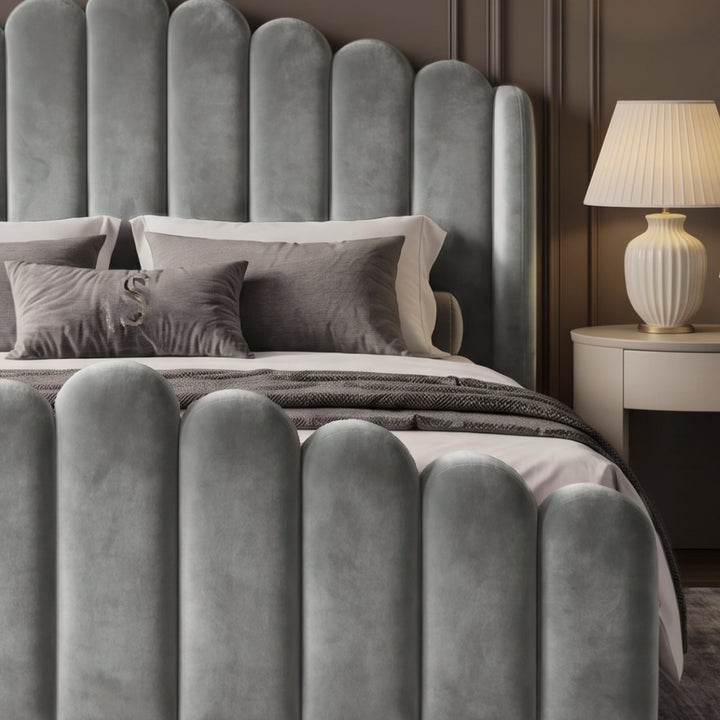 [Double | Light Grey] Close-up of scalloped light grey velvet footboard and headboard with cushions and bedside lamp