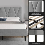 Gray upholstered bed with tufted headboard and wooden legs, featuring close-up details.