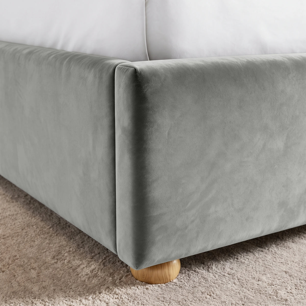 [Double | Light Grey] Close-up of upholstered footboard corner, side rail seam, velvet surface and rounded wooden foot