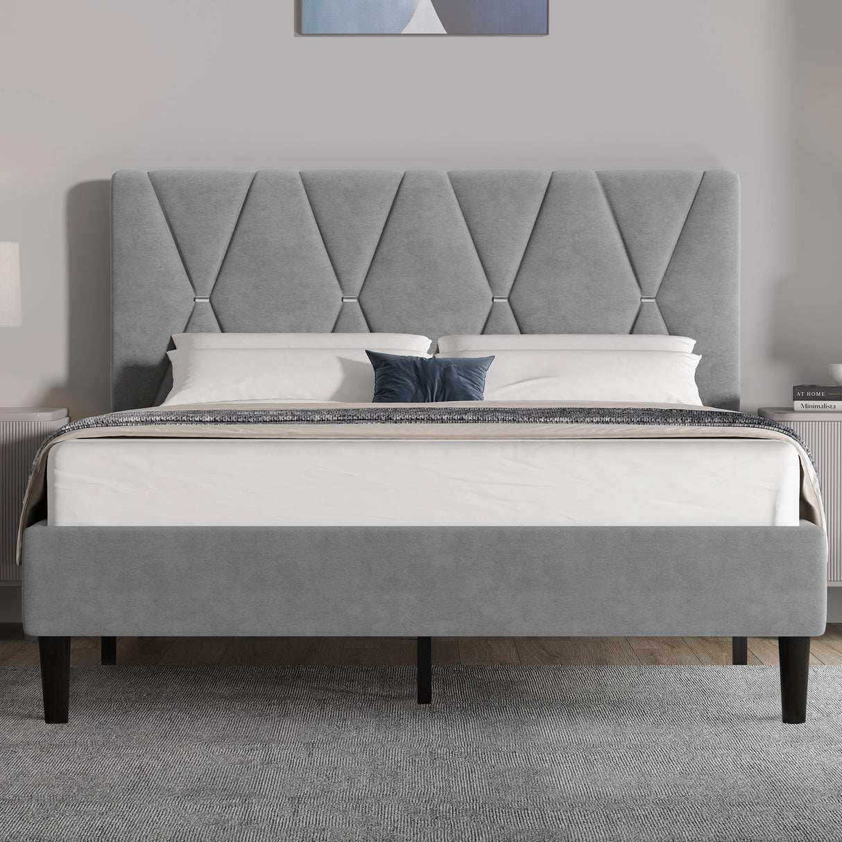 Gray upholstered bed with tufted headboard in a bedroom setting