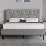 Gray upholstered bed with tufted headboard in a bedroom setting