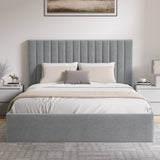 Grey upholstered bed with white bedding in a bedroom setting.