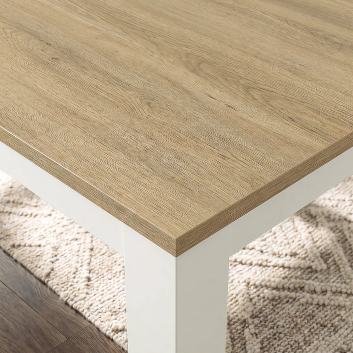 [160 cm | Light Oak] Close-up of Light Oak-grain extendable tabletop, layered edge, white frame and thick square leg above a cream rug.
