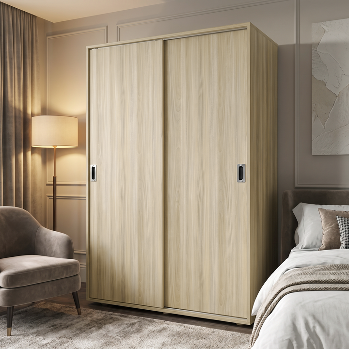 [Light Oak] Torvek wardrobe in a bedroom setting with closed sliding doors, bed, chair, and warm lamp.