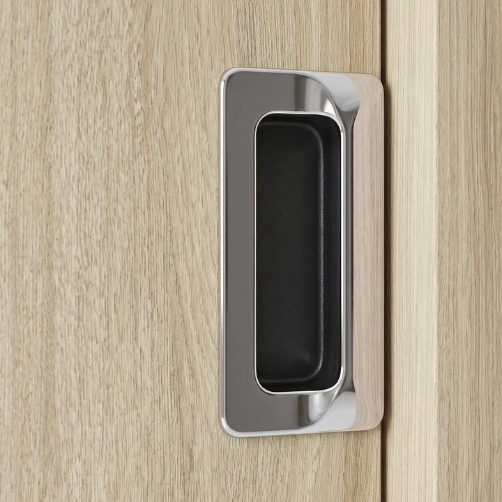 [Light Oak] Torvek recessed handle close-up showing chrome trim, black inset grip, and pale wood grain.