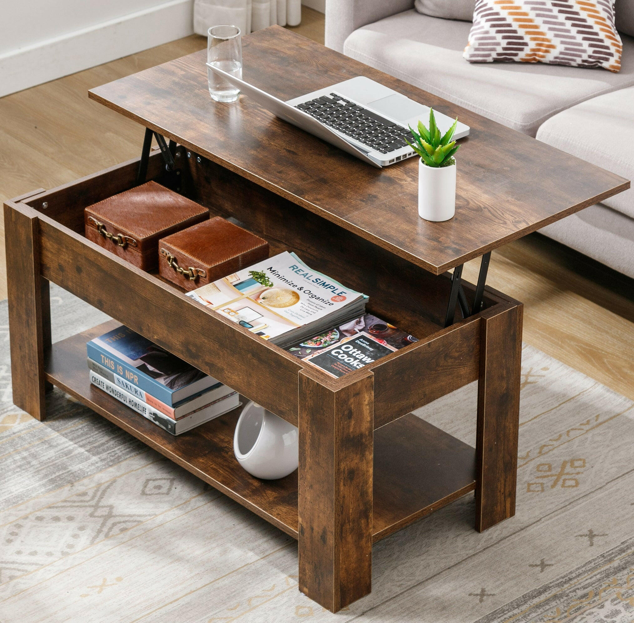 Light wood coffee table with lift top and storage space for magazines and books.