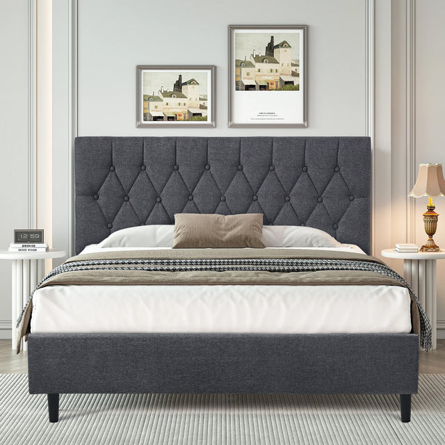 Grey linen bed frame with tufted headboard in a modern bedroom setting.