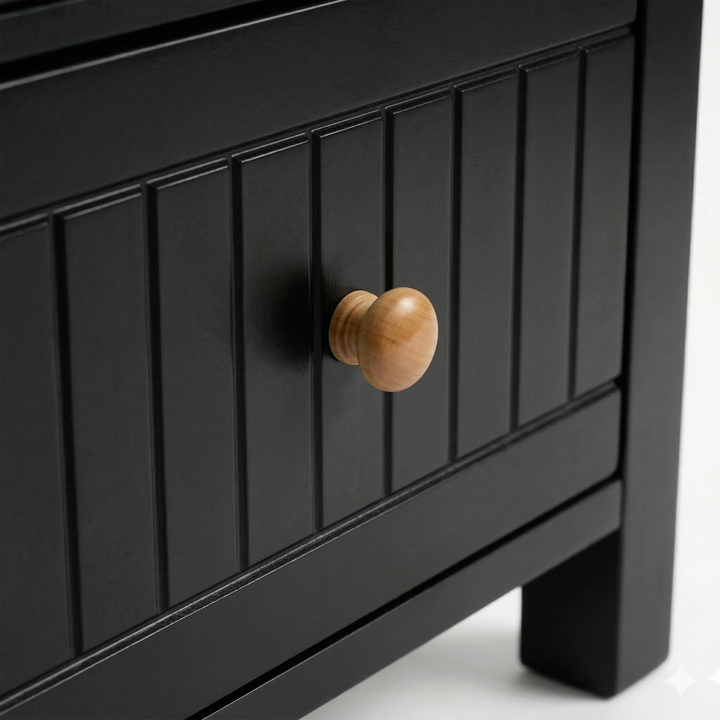 [Black] Detail of the Linra bedside table painted drawer with vertical groove lines and a natural wood pull knob