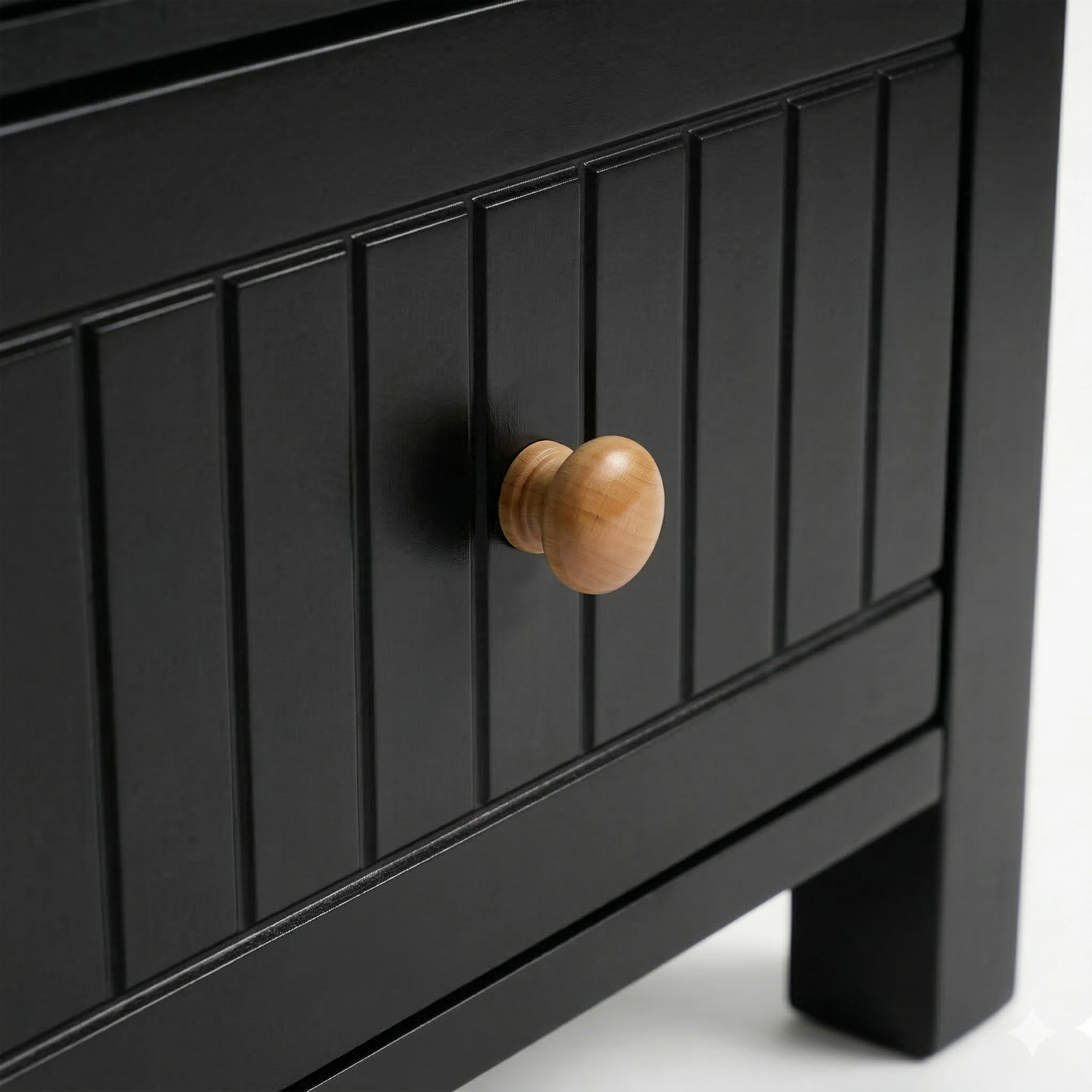 [Black] Detail of the Linra bedside table painted drawer with vertical groove lines and a natural wood pull knob