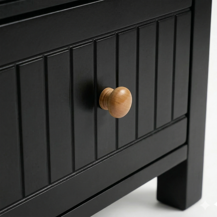 [Black] Detail of the Linra bedside table painted drawer with vertical groove lines and a natural wood pull knob
