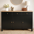 [Black] sideboard with wooden top, decorative items, and a lamp
