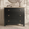 [Black] Linra chest of drawers in black with round mirror above, oak top holding vase of dried branches