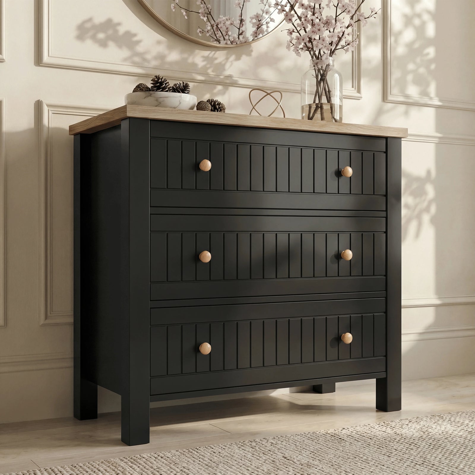 [Black] Front view Linra chest of drawers with oak top, three drawers, round wood knobs and vase above