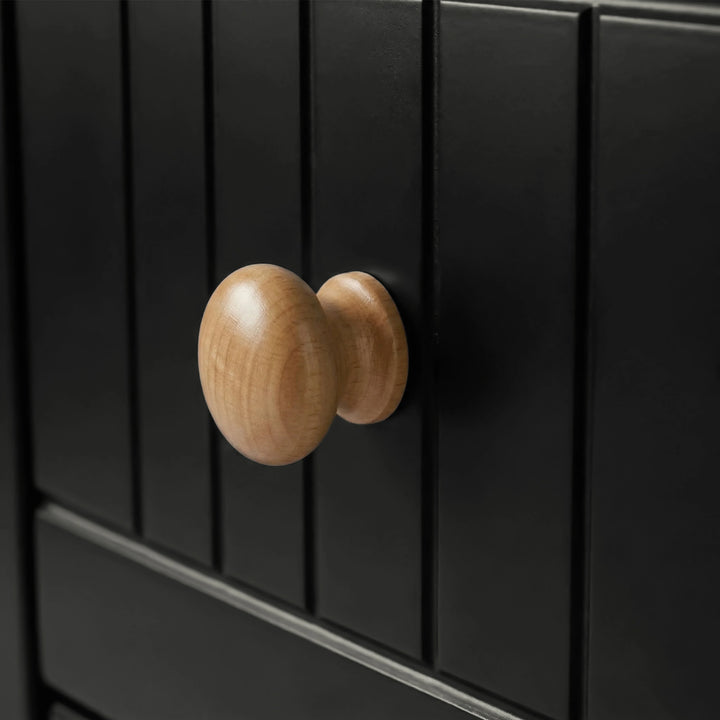 [Black] Linra chest of drawers handle close-up showing turned oak knob against vertical beaded panel