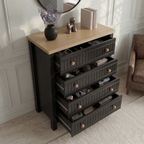 [Black] Linra 4-drawer chest with drawers open showing interior depth and accessories arranged on oak veneer top
