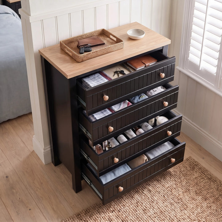 [Black] Linra 4-drawer chest with drawers open showing interior depth and accessories arranged on oak veneer top