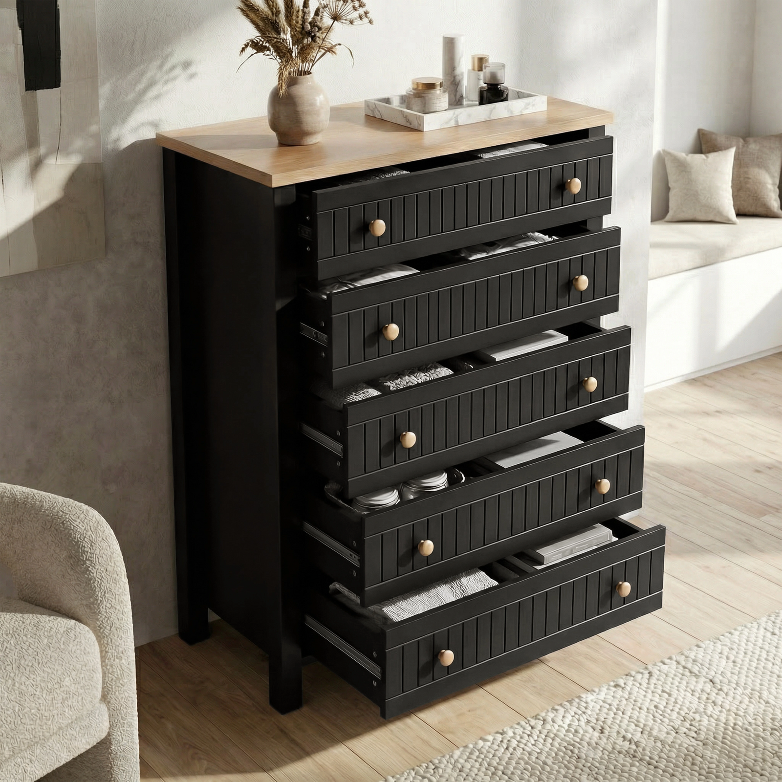 [Black] Linra 5-drawer chest with drawers open in a styled room showing interior depth and oak veneer top