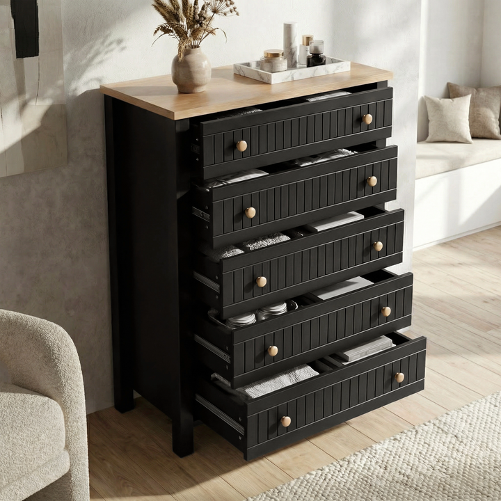[Black] Linra 5-drawer chest with drawers open in a styled room showing interior depth and oak veneer top