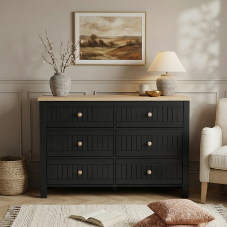 [Black] Linra 6-drawer chest front view in a styled room with neutral wall, lamp and artwork on the wall above