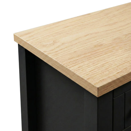 [Black] Linra 6-drawer chest close-up of the oak veneer top edge showing natural wood grain and black painted frame