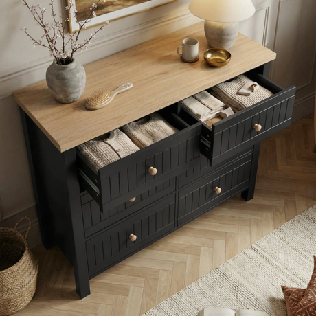 [Black] Linra 6-drawer chest with top drawer open showing interior depth and accessories arranged on oak veneer top