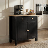 [Black] Linra sideboard against pale shaker kitchen, drawers and doors closed, coffee station arranged on top
