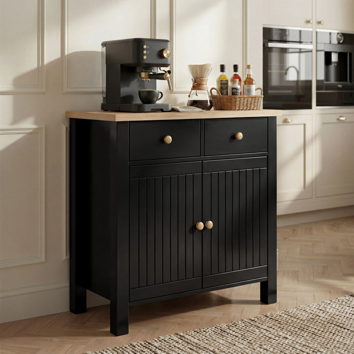 [Black] Linra sideboard against pale shaker kitchen, drawers and doors closed, coffee station arranged on top