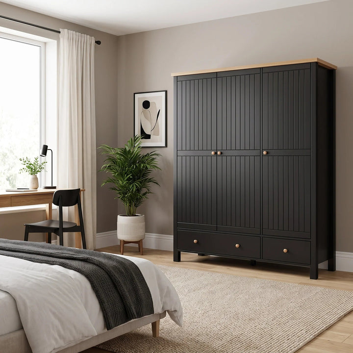 [Black] 3 door wardrobe with vertical panel doors and small round wooden knobs, styled in a bedroom setting next to a bed and potted plant.