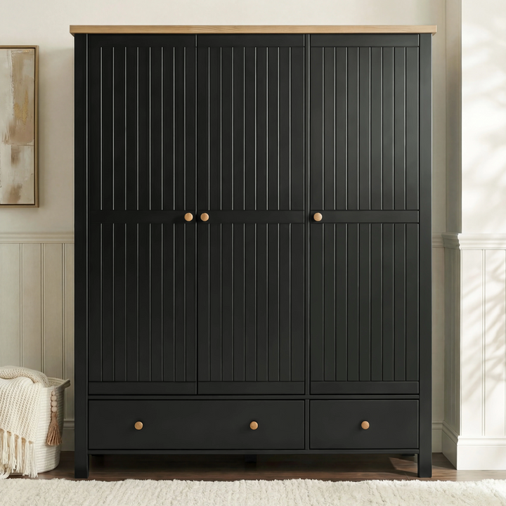 [Black] Linra 3-door wardrobe front view in a bedroom showing closed beaded panel doors and oak veneer top panel